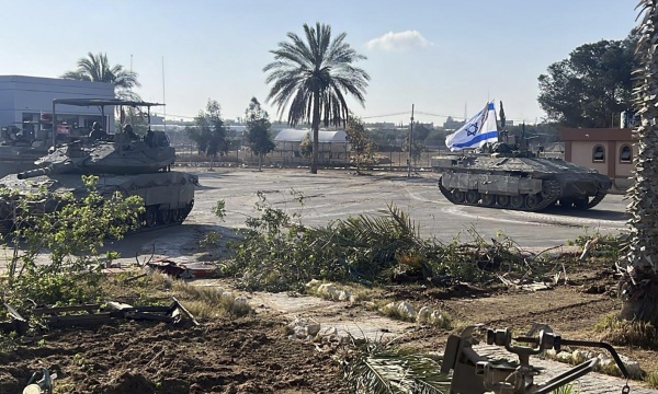 This photo provided by the Israel Defense Forces shows a tank with an Israel flag on it entering the Gazan side of the Rafah border crossing on Tuesday.