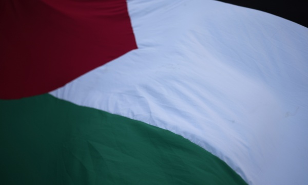 People flutter a Palestinian flag in Lisbon during a Dec. 8, 2023, demonstration in support of the Palestinian people and demanding a cease-fire in Gaza.