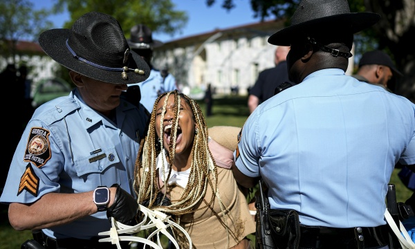 Georgia State Patrol officers detain a demonstrator on the campus of Emory University during a pro-Palestinian demonstration on Thursday, April 25, 2024, in Atlanta.