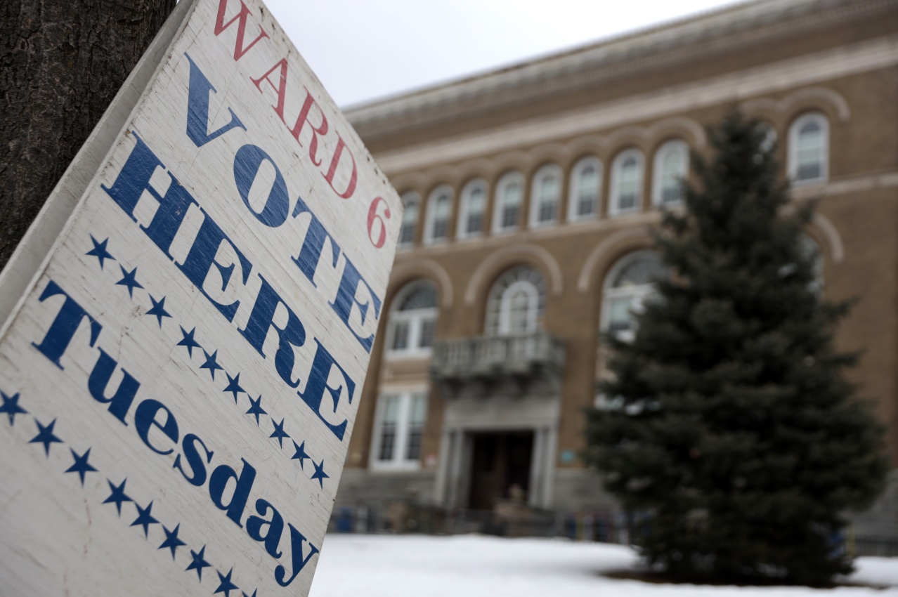 A "Vote Here Tuesday" sign is seen in Burlington, Vt., in 2020. In 2023, the city voted to allow non-U.S. citizens who are in the country legally to vote in local elections. But their turnout remains low.