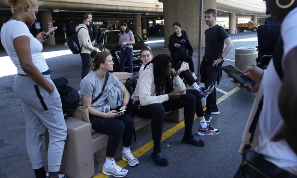 Players and staff of the New York Liberty WNBA basketball team wait to board buses at Harry Reid International Airport, Wednesday, June 28, 2023, in Las Vegas.